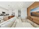 Open-concept living space with a comfortable sofa, modern lighting, and a view into the kitchen and dining areas at 646 Longboat Dr, Davenport, FL 33896