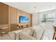Modern living room with decorative wood panel, plush sofa, and ample natural light at 646 Longboat Dr, Davenport, FL 33896