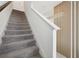 Carpeted staircase with white walls and wooden accent paneling at 646 Longboat Dr, Davenport, FL 33896