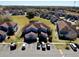 Aerial view of a condo complex with well-manicured lawns and a small pond at 658 Caribbean Dr, Davenport, FL 33897