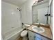 Bathroom featuring tile surround tub, a toilet, and a single sink vanity at 658 Caribbean Dr, Davenport, FL 33897