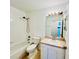 Cozy bathroom features a shower-tub combo, vanity with ample cabinet space, and decorative lighting at 658 Caribbean Dr, Davenport, FL 33897