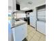 Kitchen with granite countertops, stainless appliances, laundry, and exterior view at 658 Caribbean Dr, Davenport, FL 33897