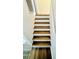 Staircase with wood-look treads and white risers with painted white walls at 658 Caribbean Dr, Davenport, FL 33897