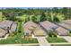 A beautiful aerial view of a single-story home with a golf course community in the background at 715 Troon Cir, Davenport, FL 33897