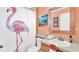 Cute bathroom featuring a flamingo-themed shower curtain and coral accents at 715 Troon Cir, Davenport, FL 33897