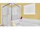 Bright bathroom with a soaking tub and a glass-enclosed shower at 715 Troon Cir, Davenport, FL 33897