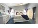 A primary bedroom features high ceilings, a ceiling fan, a large bed, and two dressers at 715 Troon Cir, Davenport, FL 33897