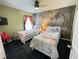 A cozy bedroom with two twin beds, flamingo bedding, and decorative wallpaper at 715 Troon Cir, Davenport, FL 33897