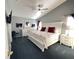 A charming bedroom features a ceiling fan, a large bed, two nightstands, and a dresser at 715 Troon Cir, Davenport, FL 33897