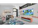 Bright living room with modern decor, comfortable seating, and entertainment center at 715 Troon Cir, Davenport, FL 33897