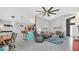 Open-concept living area featuring modern decor, tile flooring, and comfortable seating at 715 Troon Cir, Davenport, FL 33897