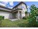 Backyard with a covered patio, green lawn, and lush landscaping at 795 W Canton Ave, Winter Park, FL 32789