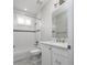 Well-lit bathroom featuring a tub-shower combo, white tiled walls and vanity, offering a clean aesthetic at 795 W Canton Ave, Winter Park, FL 32789