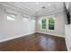 Bright bedroom with hardwood floors, tray ceiling, and large windows at 795 W Canton Ave, Winter Park, FL 32789