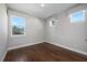 Bright bedroom with hardwood floors and three windows, offering ample natural light and serene views at 795 W Canton Ave, Winter Park, FL 32789
