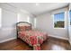 Comfortable bedroom with hardwood floors, featuring a window and a plush bed with patterned bedding at 795 W Canton Ave, Winter Park, FL 32789