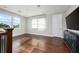Bonus room with hardwood floors, TV, multiple windows, and natural light at 795 W Canton Ave, Winter Park, FL 32789
