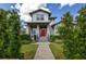 Charming two-story home with a brick pathway leading to a red front door and landscaped front yard at 795 W Canton Ave, Winter Park, FL 32789