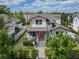 Charming two-story home showcasing a beautifully landscaped front yard and a striking red front door at 795 W Canton Ave, Winter Park, FL 32789