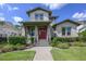 Charming two-story home featuring a striking red front door and professionally landscaped front yard at 795 W Canton Ave, Winter Park, FL 32789