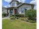 Well-maintained front yard with lush green grass, mature landscaping, and a brick pathway leading to the entrance at 795 W Canton Ave, Winter Park, FL 32789