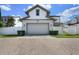 Charming two-story home with a two car garage, manicured landscaping, and a brick driveway at 795 W Canton Ave, Winter Park, FL 32789