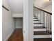 Hallway with a coat rack and a staircase with dark wood steps and an iron railing at 795 W Canton Ave, Winter Park, FL 32789