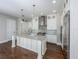 Kitchen boasts white cabinets, stainless steel appliances, center island, and hardwood flooring at 795 W Canton Ave, Winter Park, FL 32789