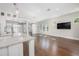 Open-concept living room with hardwood floors, modern lighting, and a kitchen island at 795 W Canton Ave, Winter Park, FL 32789