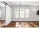 Bright living room features three windows, hardwood floors and modern chandelier at 795 W Canton Ave, Winter Park, FL 32789
