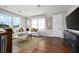Upstairs living room with hardwood floors, natural light from multiple windows, and a cozy seating area at 795 W Canton Ave, Winter Park, FL 32789