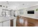 Open-concept living room with hardwood floors, modern lighting, and a kitchen island at 795 W Canton Ave, Winter Park, FL 32789