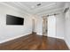 Main bedroom boasts ensuite bathroom, hardwood floors, barn door, and tray ceiling at 795 W Canton Ave, Winter Park, FL 32789