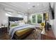 Serene main bedroom with tray ceilings, hardwood floors, and an abundance of natural light at 795 W Canton Ave, Winter Park, FL 32789