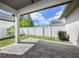 Covered patio features a brick-paved floor and a view of the fenced backyard at 795 W Canton Ave, Winter Park, FL 32789
