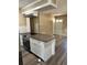 Well-designed kitchen island with cooktop, granite counters, and white cabinets for ample storage space at 804 Little Wekiwa Dr, Altamonte Springs, FL 32714