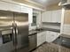 Modern kitchen featuring stainless steel appliances, granite countertops, and white cabinetry at 804 Little Wekiwa Dr, Altamonte Springs, FL 32714