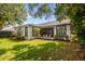 Spacious backyard with a screened-in patio area, perfect for outdoor seating and entertaining, surrounded by lush greenery at 8440 Woburn Ct, Windermere, FL 34786