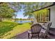 Inviting backyard patio with comfortable seating, offering serene views of the pond and lush greenery, perfect for relaxation at 8440 Woburn Ct, Windermere, FL 34786
