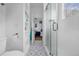 Bathroom with a walk-in glass shower and blue patterned flooring, storage shelves on the left at 8440 Woburn Ct, Windermere, FL 34786