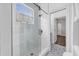 Bathroom featuring a glass walk-in shower, herringbone tile walls, and patterned tile floor at 8440 Woburn Ct, Windermere, FL 34786