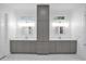Elegant bathroom with double sinks, stylish gray cabinetry, and sleek fixtures at 8440 Woburn Ct, Windermere, FL 34786
