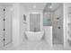 Modern bathroom with a sleek tub and a glass shower in a bright space at 8440 Woburn Ct, Windermere, FL 34786