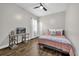 Bedroom featuring hardwood floors, a desk and TV, and natural light from the window at 8440 Woburn Ct, Windermere, FL 34786