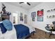 Bright bedroom featuring a navy blue comforter, hardwood floors, and hockey memorabilia on the wall at 8440 Woburn Ct, Windermere, FL 34786