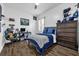 Cozy bedroom with blue accents, a desk and hard wood floors at 8440 Woburn Ct, Windermere, FL 34786