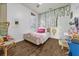 Bedroom featuring hardwood floors, ivy vines, and a desk at 8440 Woburn Ct, Windermere, FL 34786