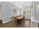 Elegant dining room with a long table, decorative lighting, and a serene color scheme at 8440 Woburn Ct, Windermere, FL 34786