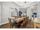 Open dining area with a large wood table, stylish light fixtures, and a view of the living area at 8440 Woburn Ct, Windermere, FL 34786